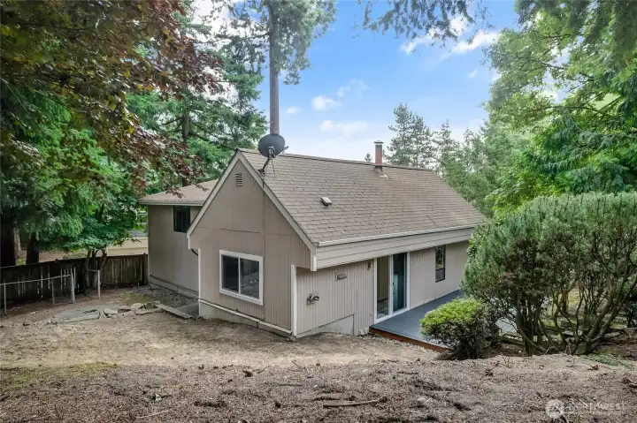 Rear of home with glimpse of deck Rear of home with glimpse of deck