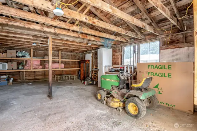 Inside the HUGE shop/garage! Riding lawn mower conveys with the home!