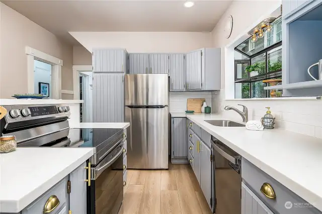 New lighting above the sink, new flooring in the refreshed kitchen.