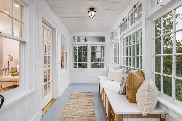 The house has a front entry sun room.