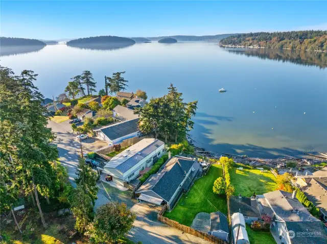 Aerial View of Home Fronting Padilla Bay - The Best Crabbing and Oysters on the Island!  Home is Center in photo with Dark Roof and Large Grass Sideyard