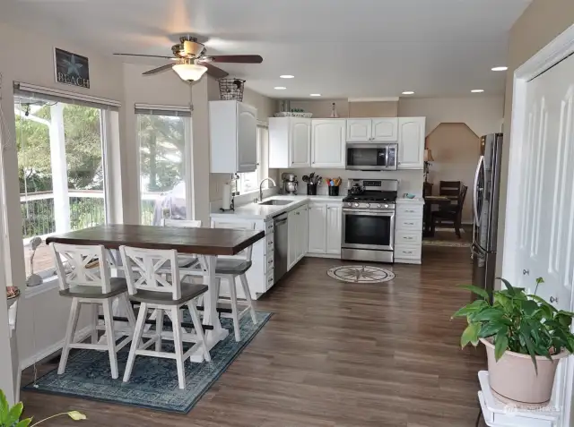 Kitchen and Kitchen Nook w/ vinyl-plank flooring.  (Pantry closet is on the right.)