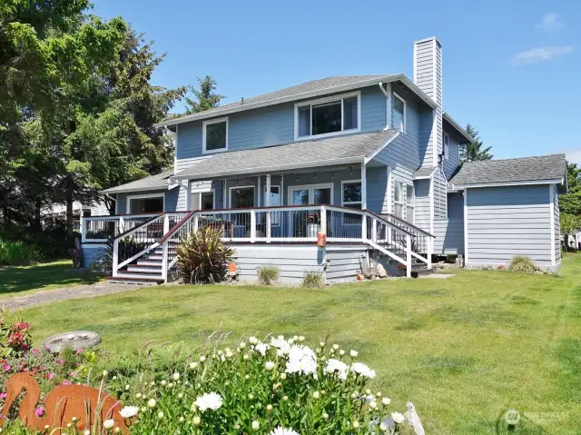 Rear view of the home w/ landscaped yard.  (Shed is on the right.)