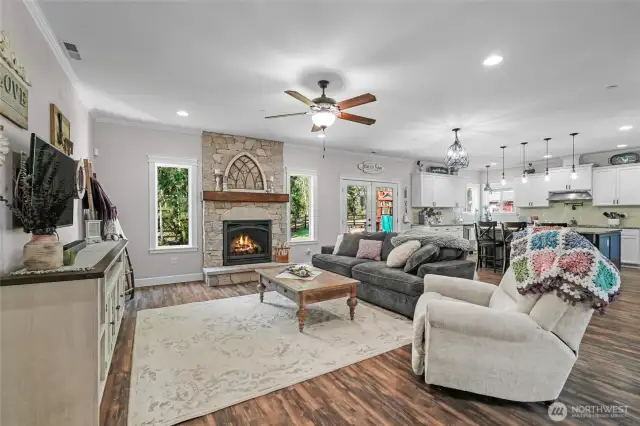 Family room open to kitchen with custom gas burning fireplace.
