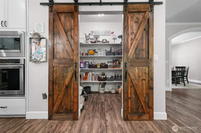 Large pantry with custom barn door.
