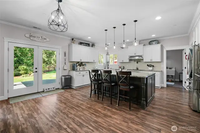 French doors off kitchen leading to covered back patio and private backyard.