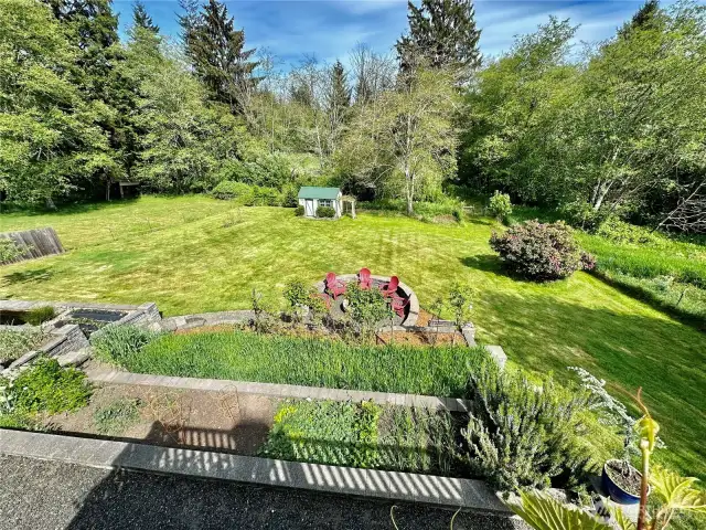 This beautiful view of the rear yard and gardens is from the deck just off the dining room.