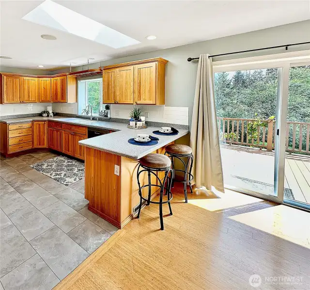 The open floor plan is light and airy with lots of windows, slider and skylight.