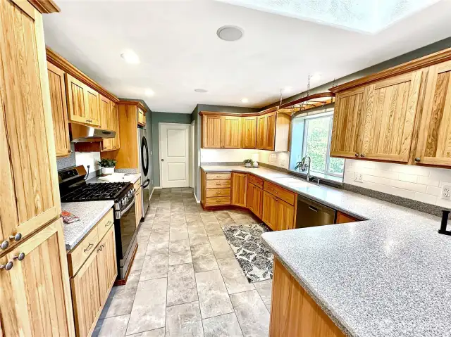 The door at the end of the kitchen opens to the large utility room.  There is also a powder room just off the laundry room with easy access from the kitchen, laundry and garage areas.