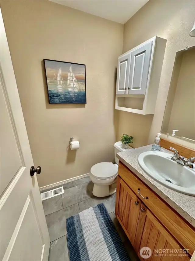 Powder room conveniently located between the garage and kitchen.  An added features is the solar tube for natural light all day long!
