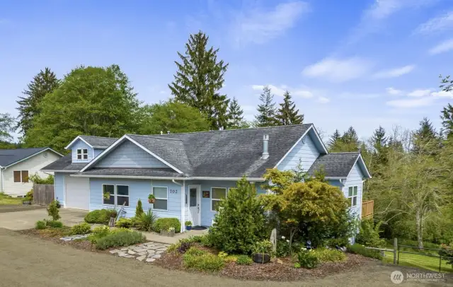 Attractive rambler with walk-out basement on .76-acre lot offering serene views, gardener's dream landscaping and RV parking.