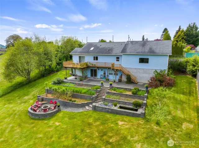 Terraced backyard with perennial gardens, water feature and fire-pit just add to the outdoor enjoyment.
