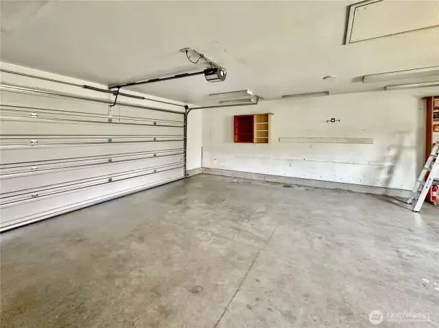 Oversize, attached 2 car garage with electric door opener, heater and side door granting access to the rear deck and grounds.