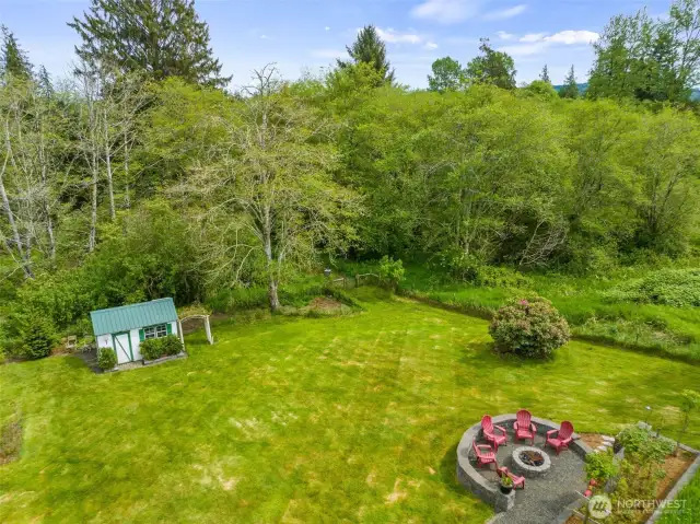 Beautiful grounds with garden space, fireplace pit, water feature, terraced beds and perennials everywhere.
