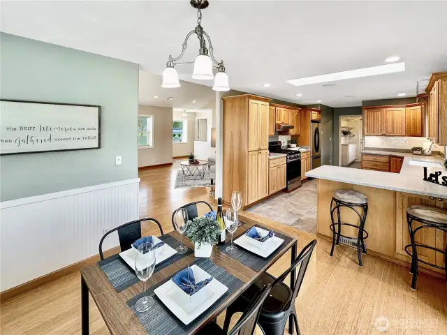 Ample dining space with room for your table plus eating space at the kitchen counter.  Tastefully decorated with bamboo floor and wrap around bead-board wainscoting.