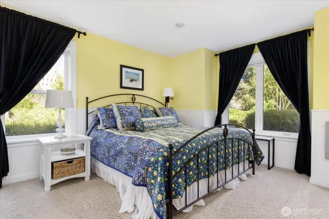 On the lower level is a Guest Suite (bedroom #3) with beadboard walls, custom curtains & blinds, a large double door closet and plush carpeting. Room accommodates a King-size bed.