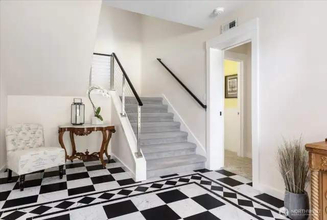 Marbled Front Entry with stairs to the upper levels (2nd & 3rd floors), and the doorway to the Guest Room and Office areas.  New Metal Stair Railings for all three floors installed in 2016. New Gray Carpeting on 2nd & 3rd floors installed in 2017.