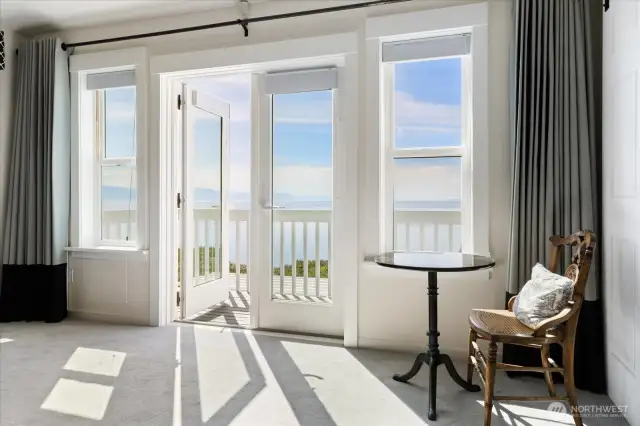 French doors out to "Primary Ensuite" deck, sitting area, and custom curtains.