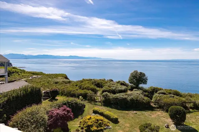 Experience views of the back yard gardens, the Puget Sound, and the Olympic mountains from the "Primary Ensuite" private deck.