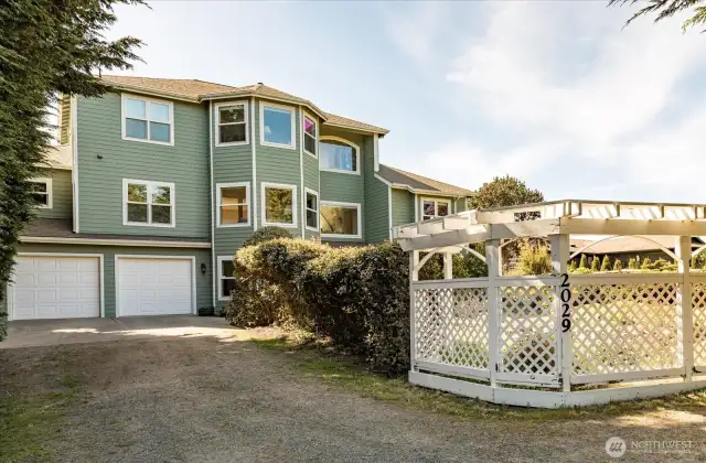 As you enter the driveway to the home, you are greeted by a wood trellis and gardens, and the entrance to the 3-story luxury home. Spacious 2-Car garage on the lower level.