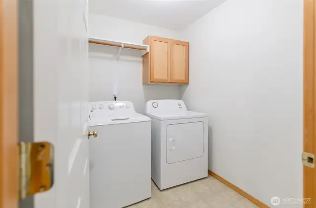Main floor utility room with storage space.  Washer and dryer included with the sale.