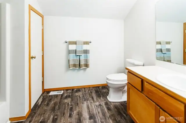 Upstairs bathroom has a full bath and linen closet.  Centrally located off bonus area and both bedrooms.