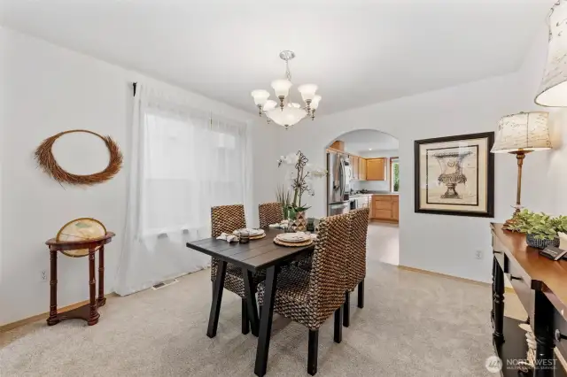 Located between the kitchen and formal living room, this area will comfortably fit several guests around the table.