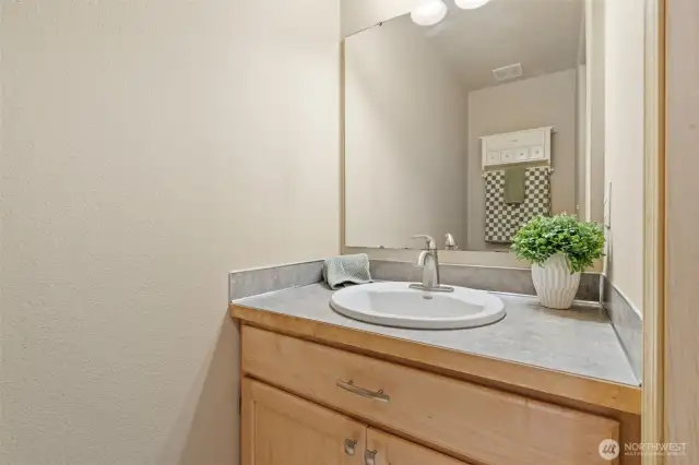 Powder room is located down the hallway for extra privacy.