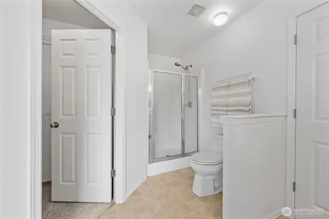 View of the walk-in closet and stand-alone shower.  Pony wall provides additional privacy.