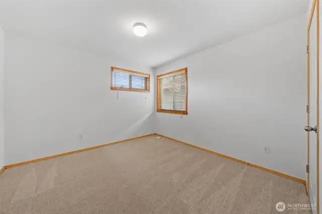 Bedroom #1. Window pop faces the front of the home and the large window looks out to the side yard.