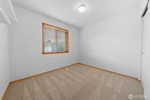 Bedroom #3.  Window looks out to the backyard.