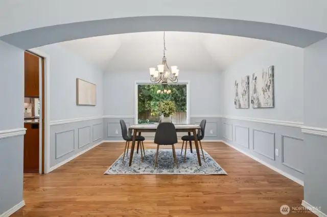 Another gorgeous room with hardwoods, newer light fixture, large window looking out at the backyard. Lots of room here to add additional furniture pieces.