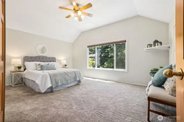 As we move upstairs, just to the right is the massive primary bedroom, with double-door entry and ceiling fan.