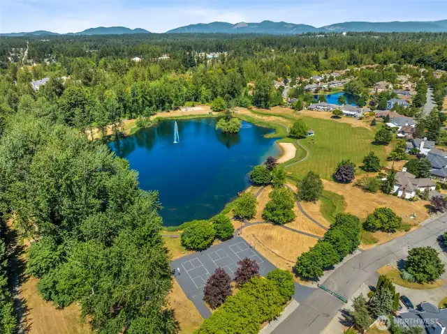This view of the larger lake shows the sport court and the start of the trail system. The HOA even stocks the lake with fish so neighbors can catch and release.