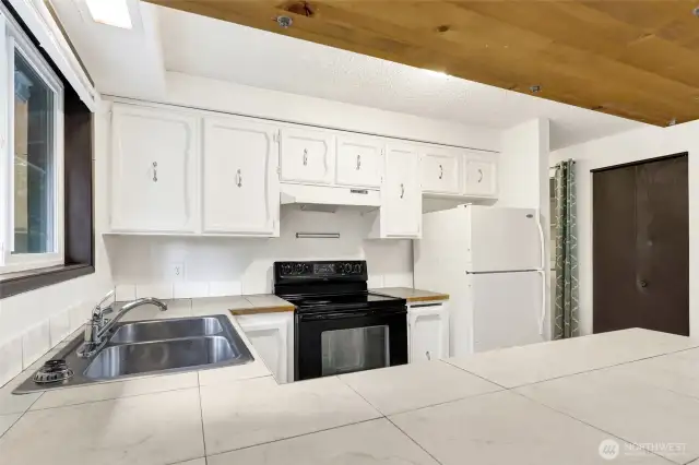 Wood cabinets.  Tile counter tops.  Wood trim.  All appliances / fixtures work!