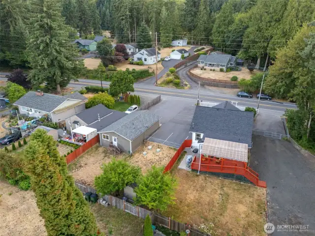 The back side of the home with access ramp to back deck, and stairs to parking area.