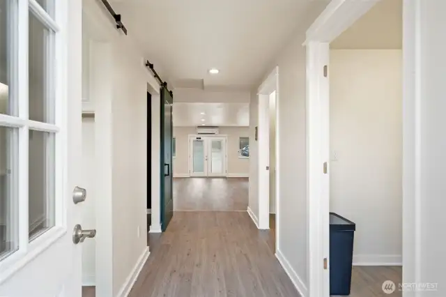 Looking from the back entry into the salon. Kitchen area on the right.