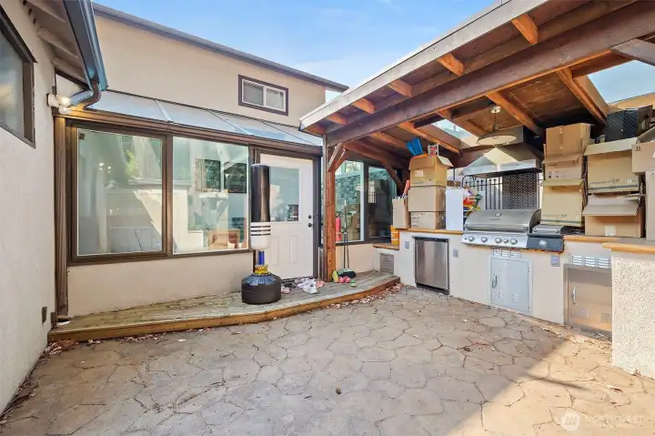 Backyard patio with access to sunroom.
