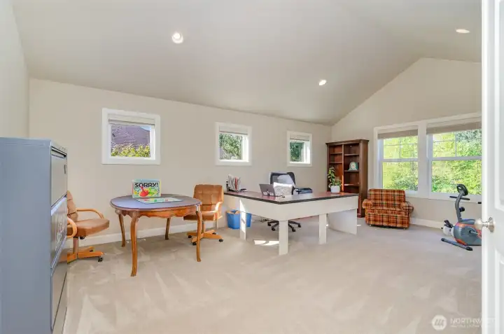 The upstairs bonus room features a vaulted ceiling, deck & plenty of space for the pool table or home theater.