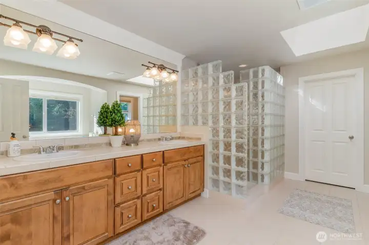 Primary Suite 5- piece bathroom with a walk-in closet.