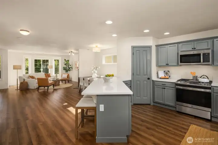 Updated kitchen with fresh surfaces, stainless appliances, and open sightlines to dining and living — great for gatherings.
