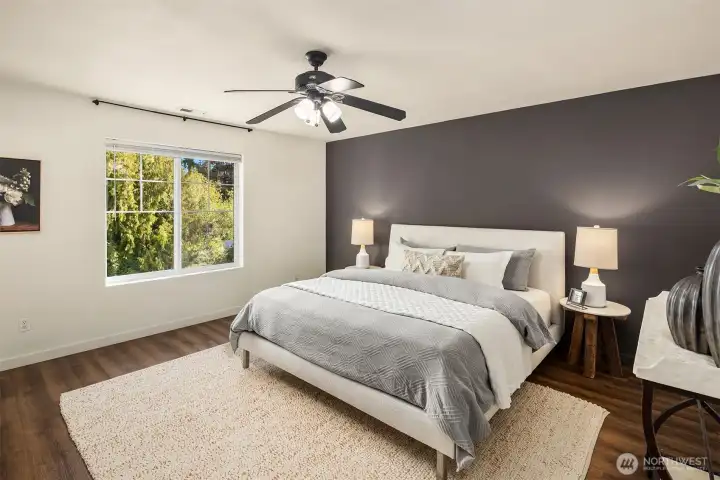 Relaxing primary suite with modern palette, walk-in closet, and ensuite bath.