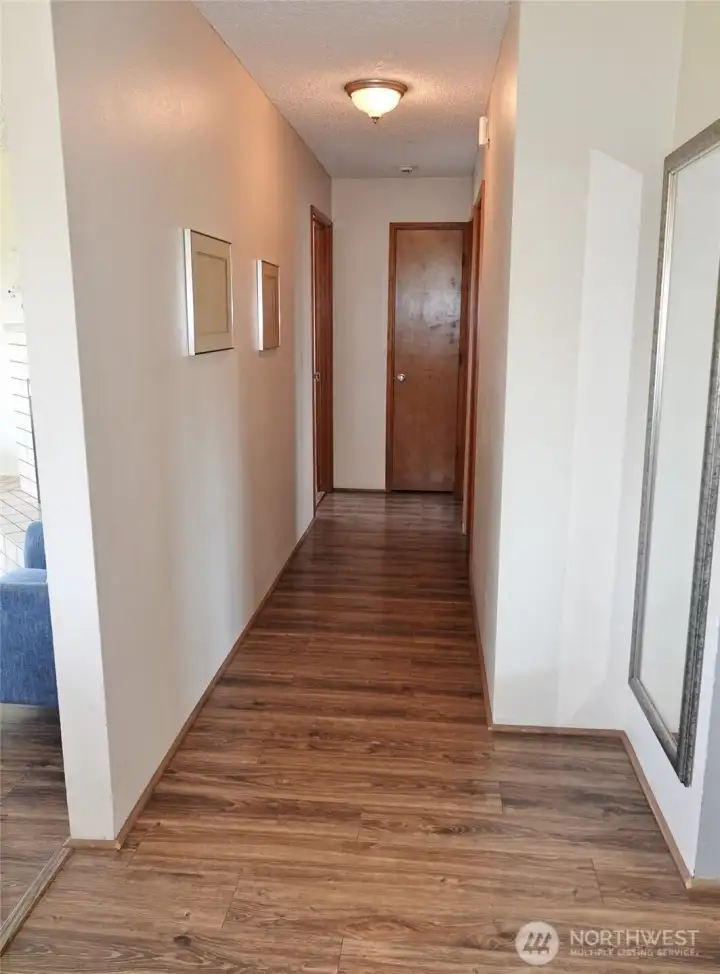 Hallway leading to the bedrooms and full-bathroom.