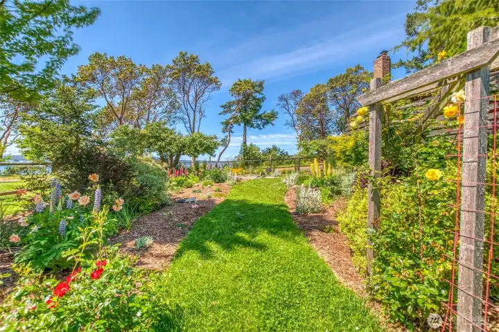Mature landscape features flowers and raised beds.