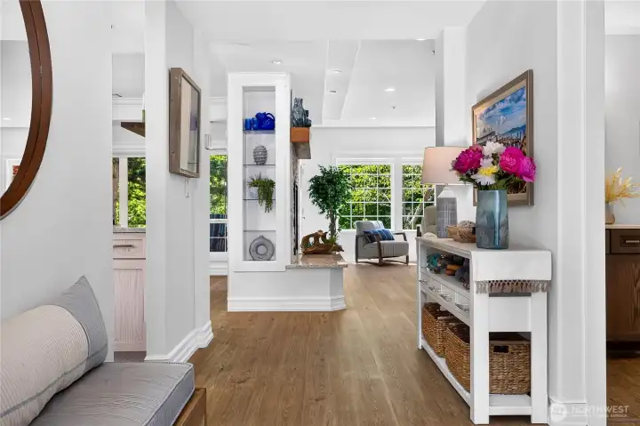 Welcoming entry and hallway showcasing updated flooring, custom finishes, and bright interior spaces.