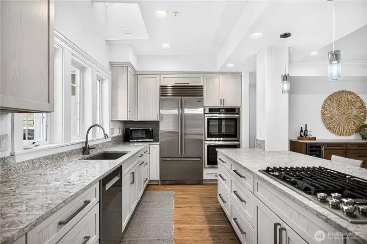 Remodeled kitchen with Cambria countertops, custom cabinetry, premium appliances, and abundant workspace.