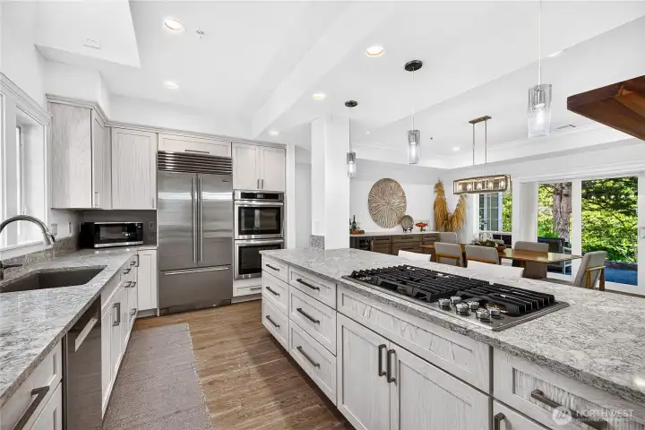Spacious chef's kitchen with gas cooktop, custom storage, and seamless connection to the main living areas.