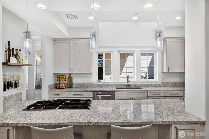 Updated kitchen featuring a large center island, Sub-Zero refrigerator, and modern finishes throughout.