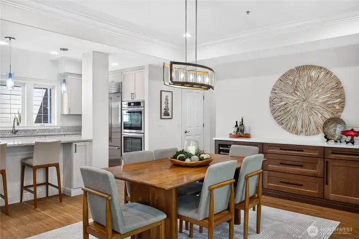 Dining space with custom built-in cabinetry, wine cooler, and convenient access to the kitchen.