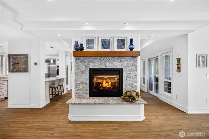 Comfortable living room featuring a gas fireplace, updated finishes, and spacious gathering areas.